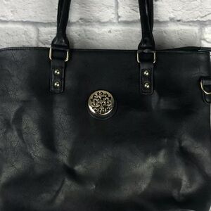 Faux leatherer purse withh metal decorative piece